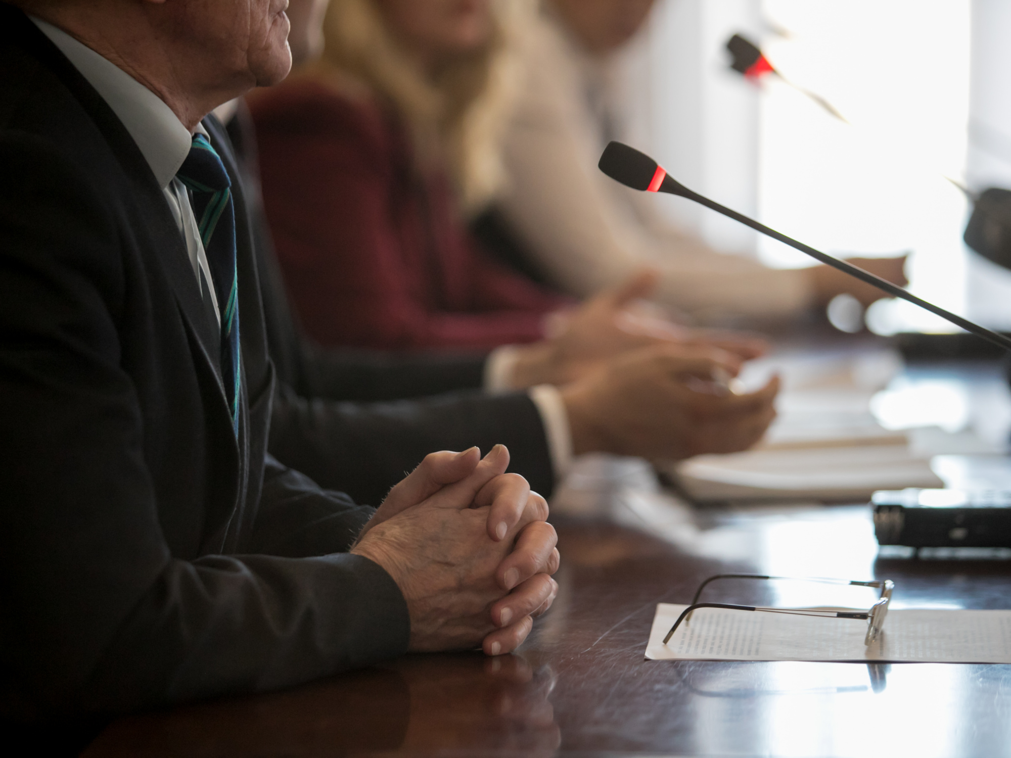 panelists at a table with microphones pointed towards them