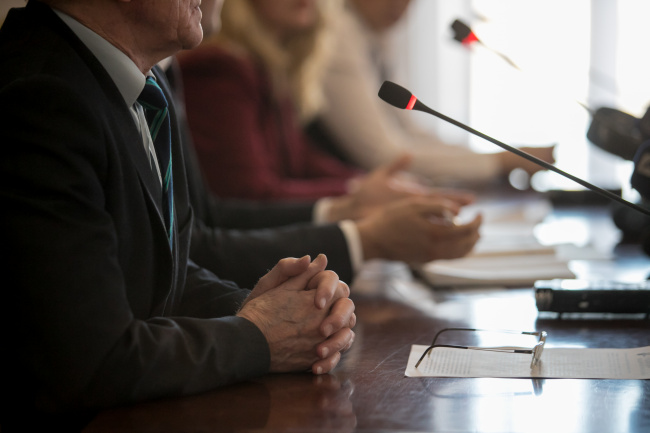 panelists at a table with microphones pointed towards them