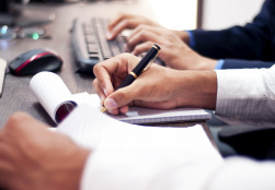 closeup of mans hand crunching some numbers